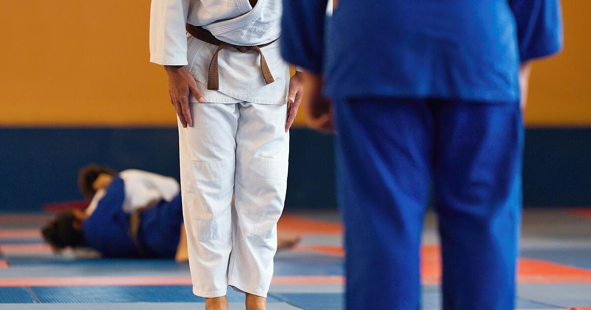 Two practitioners testing their skills in BJJ competition